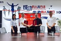 Photo of the two parties signing the agreement